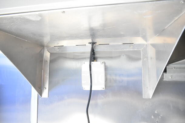 Rock Solid Cargo 8.5'x28' food trailer shell interior with CaptiveAire grease hood and visible wiring, ready for equipment.