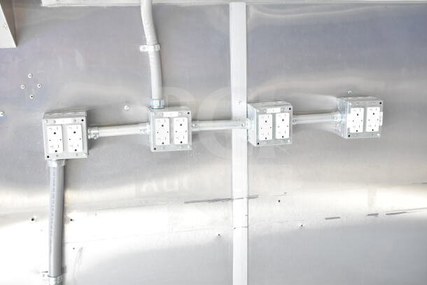 Rock Solid Cargo 8.5'x28' food trailer shell interior, featuring CaptiveAire grease hood and electrical outlets.