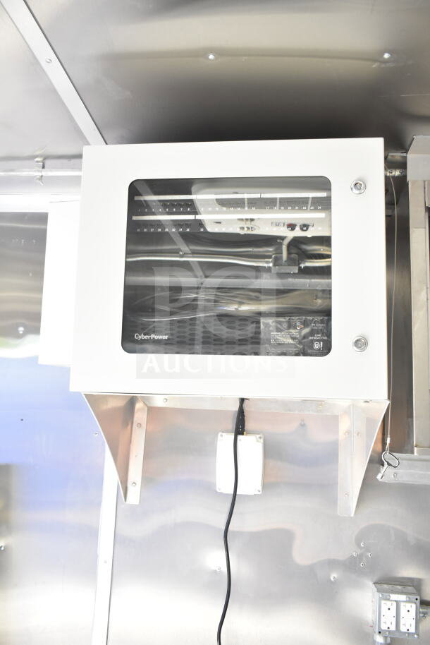 Rock Solid Cargo food trailer shell interior, featuring a mounted CyberPower unit and stainless steel walls, ready for customization.