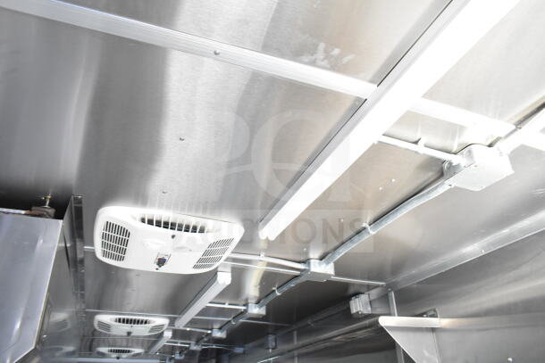 Rock Solid Cargo 8.5'x28' food trailer interior, featuring CaptiveAire grease hood and lighting, ready for equipment installation.