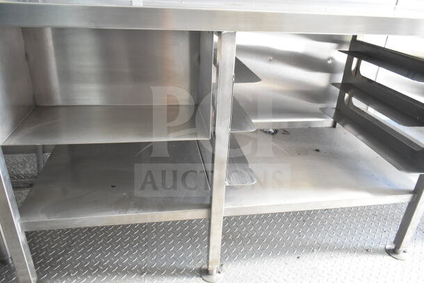 Rock Solid Cargo 8.5'x28' food trailer shell interior, featuring stainless steel shelves and CaptiveAire grease hood.