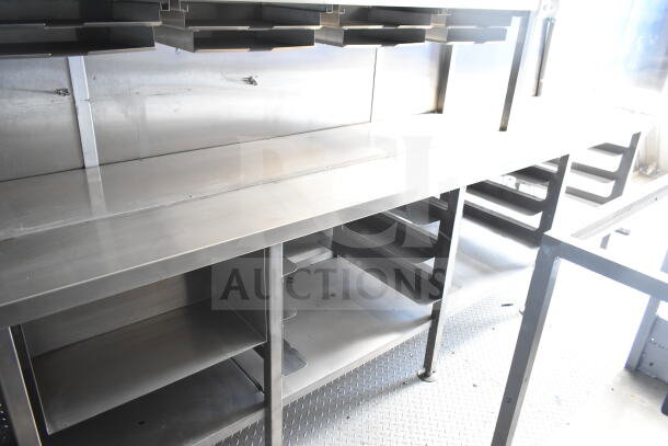 Rock Solid Cargo 8.5'x28' food trailer shell interior with stainless steel counters and CaptiveAire grease hood. Ready for equipment.