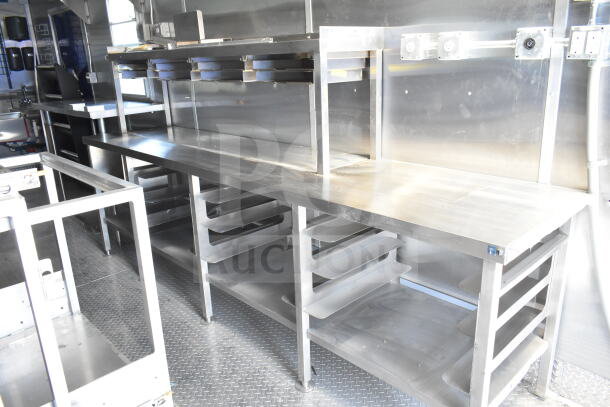 Rock Solid Cargo 8.5'x28' food trailer shell featuring CaptiveAire grease hood; ready for customization; stainless steel interior.