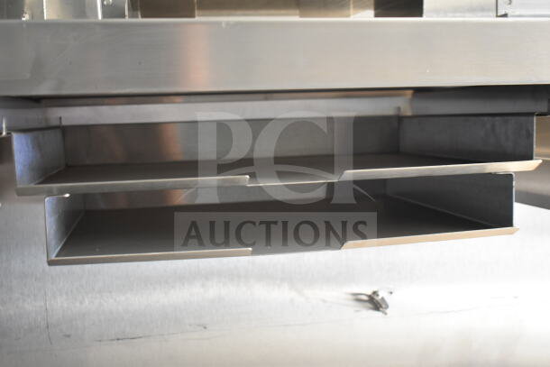 Stainless steel CaptiveAire grease hood inside Rock Solid Cargo 8.5'x28' food trailer shell, ready for equipment installation.