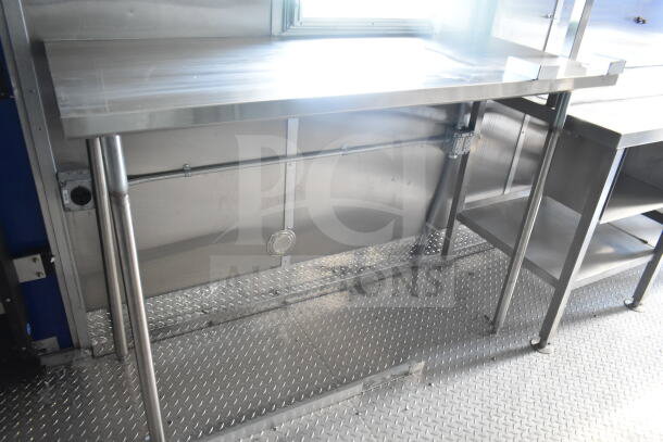 Rock Solid Cargo 8.5'x28' food trailer shell interior. Features stainless steel counters and CaptiveAire grease hood, ready for outfitting.