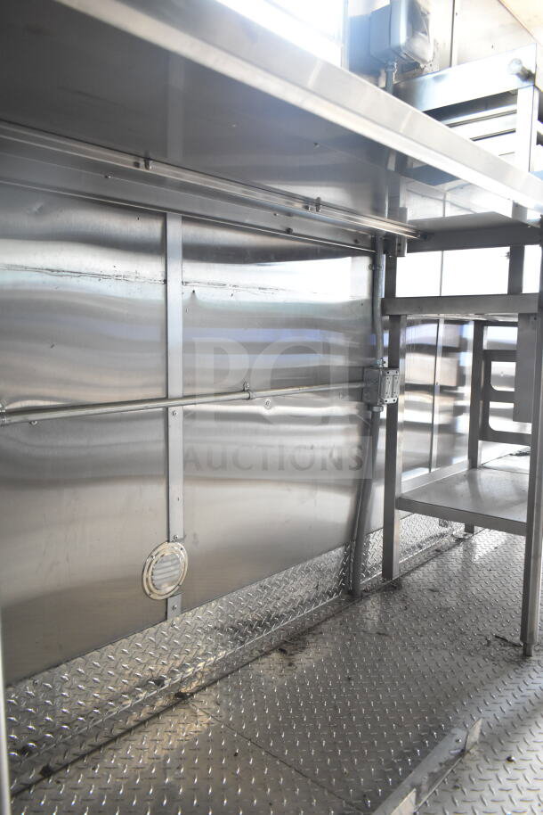 Rock Solid Cargo 8.5'x28' food trailer interior, featuring CaptiveAire grease hood and diamond plate flooring, ready for custom outfitting.