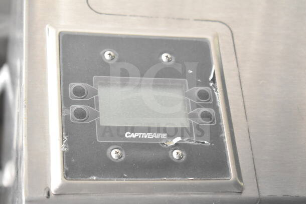 CaptiveAire grease hood control panel on Rock Solid Cargo food trailer shell, minor wear visible.