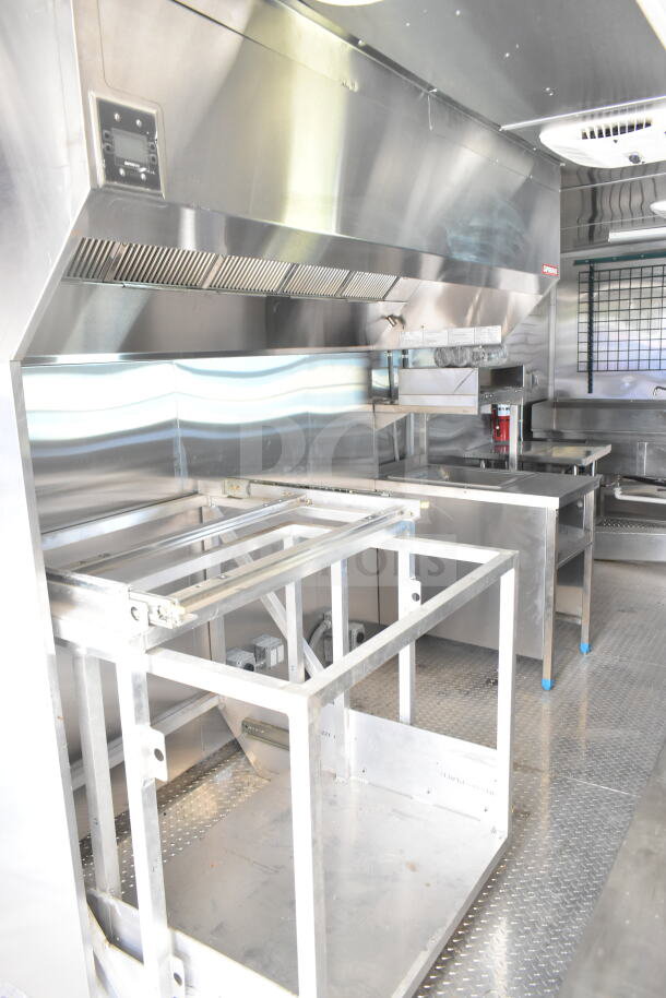 Rock Solid Cargo 8.5'x28' food trailer interior with CaptiveAire grease hood, ready for custom equipment installation.