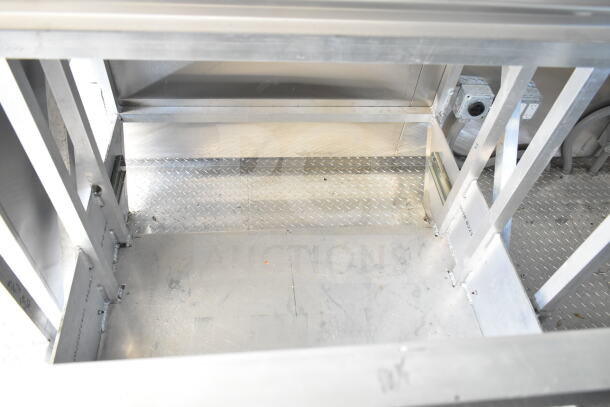 Rock Solid Cargo 8.5'x28' food trailer shell interior with CaptiveAire grease hood, unfinished, ready for customization.