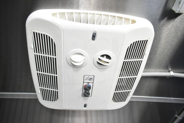 Interior view of Rock Solid Cargo 8.5'x28' food trailer, featuring CaptiveAire grease hood and ventilation system.