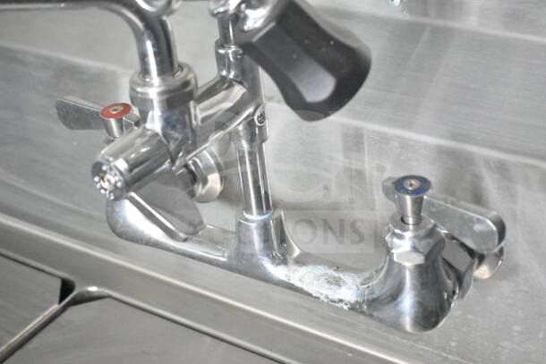 Stainless steel faucet inside Rock Solid Cargo 8.5'x28' food trailer shell. Features CaptiveAire grease hood, ready for outfitting.
