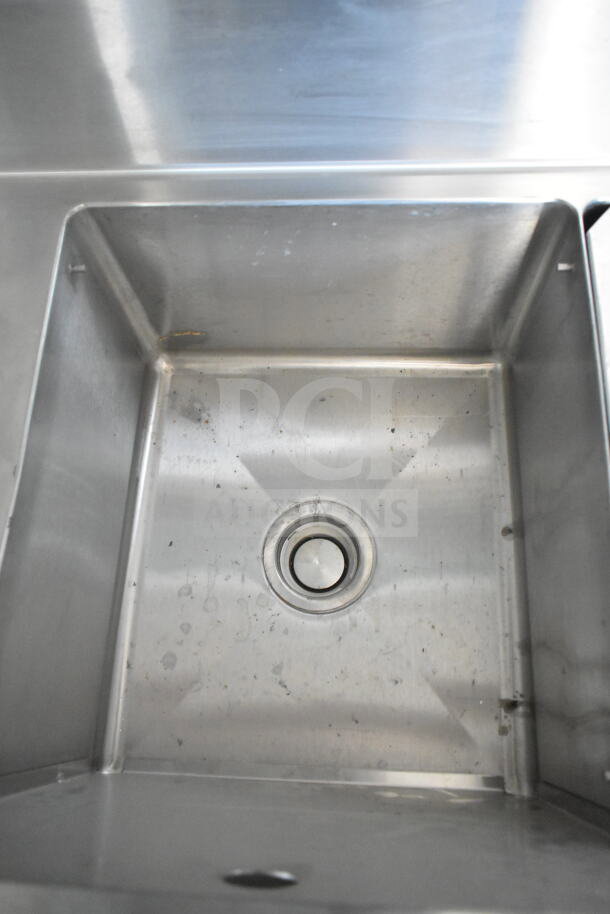 Stainless steel sink in Rock Solid Cargo 8.5'x28' food trailer shell, includes CaptiveAire grease hood, ready for customization.