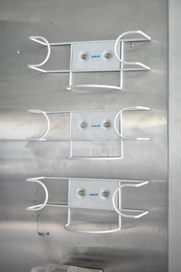 Interior view of Rock Solid Cargo 8.5'x28' food trailer shell, featuring Ecolab soap dispenser holders mounted on a stainless steel wall.