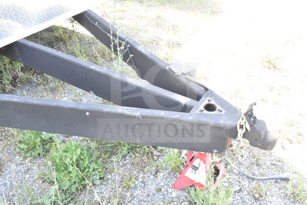Rock Solid Cargo trailer hitch, sturdy metal, minor wear, ready for customization. Includes chain and jack for stability.