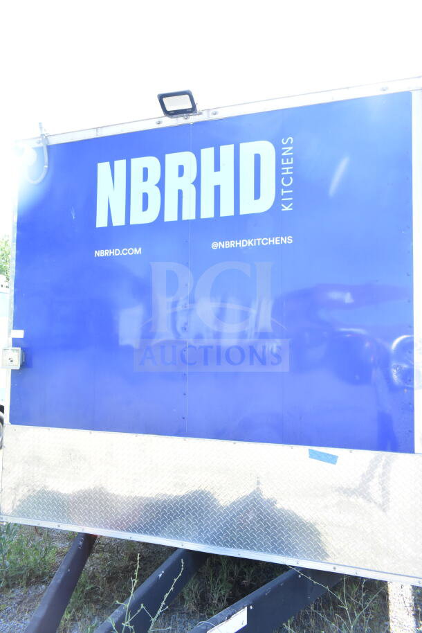Rock Solid Cargo 8.5'x28' food trailer shell with CaptiveAire grease hood. Features NBRHD Kitchens branding.