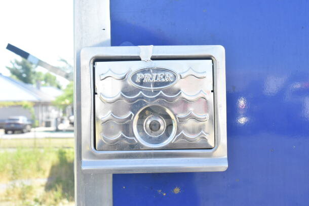 Close-up of a stainless steel Prier access panel on a blue Rock Solid Cargo 8.5'x28' food trailer shell.