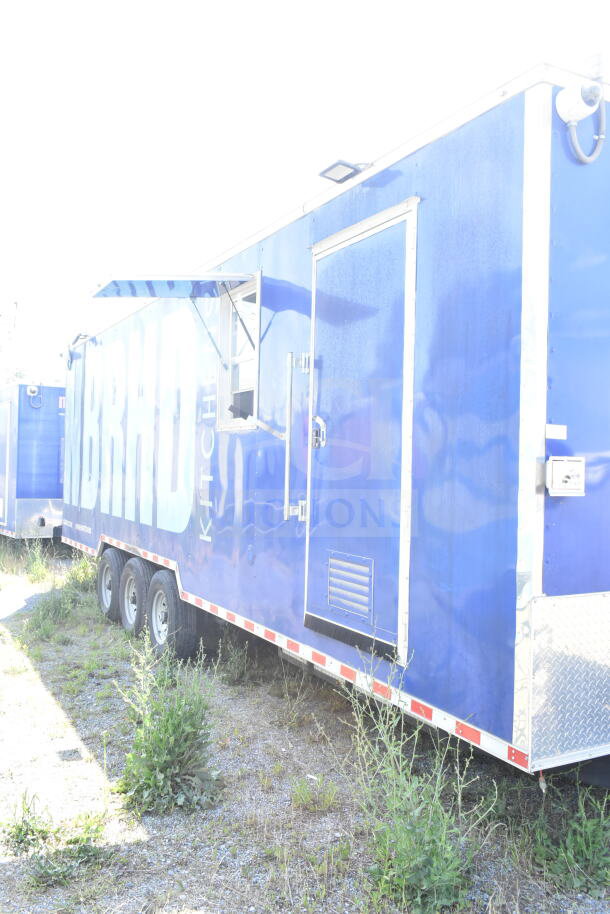 Rock Solid Cargo 8.5'x28' blue food trailer shell with CaptiveAire grease hood and side window, ready for customization.