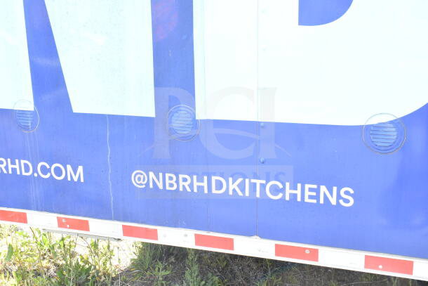Rock Solid Cargo 8.5'x28' Food Trailer Shell with CaptiveAire grease hood, blue exterior with "@NBRHDKITCHENS" text. Ready for outfitting.