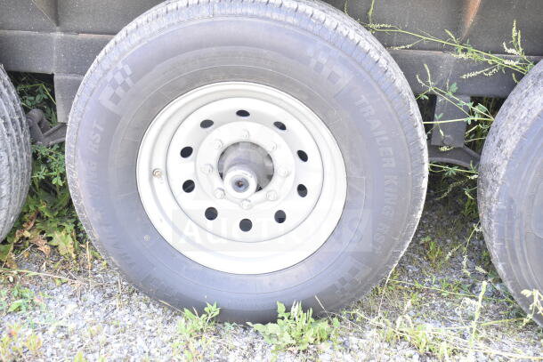 Trailer tire of Rock Solid Cargo 8.5'x28' food trailer shell, features CaptiveAire grease hood, ready for customization.