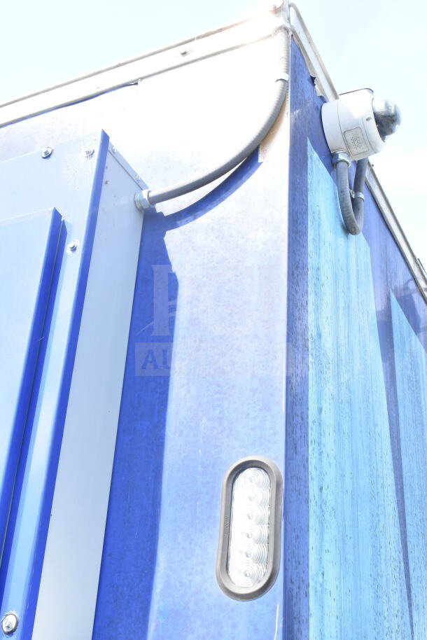 Rock Solid Cargo 8.5'x28' food trailer shell, blue exterior, equipped with CaptiveAire grease hood, ready for customization.