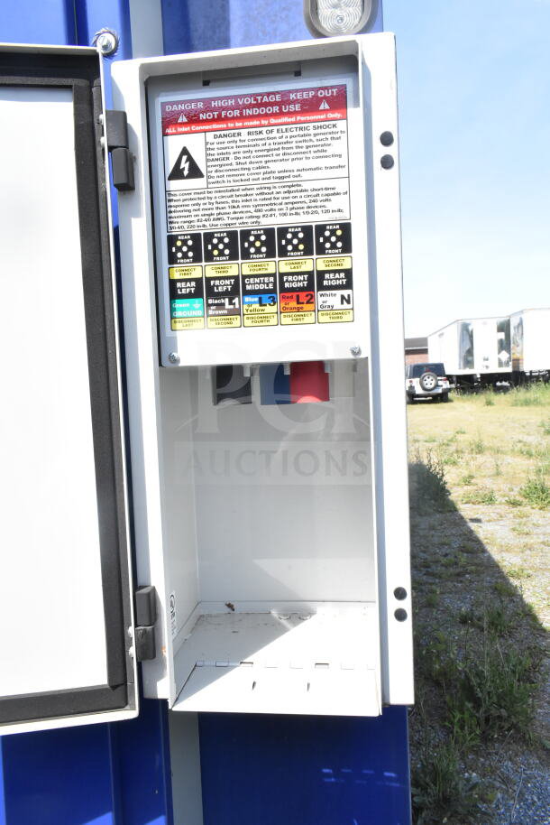 Electrical control panel on Rock Solid Cargo 8.5'x28' food trailer shell, featuring high voltage warning labels.