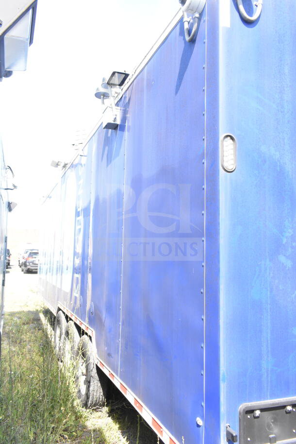 Rock Solid Cargo 8.5'x28' food trailer shell, blue exterior, with CaptiveAire grease hood. Ready for equipment installation.