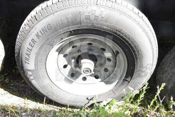 Trailer King RST tire attached to a Rock Solid Cargo 8.5'x28' food trailer shell. Includes CaptiveAire grease hood.