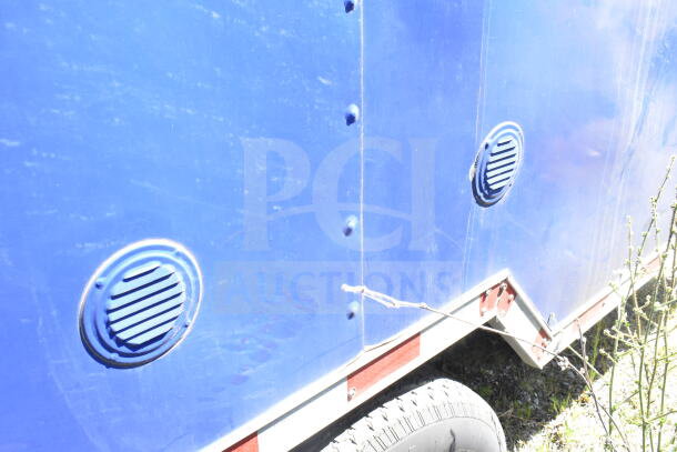 Rock Solid Cargo 8.5'x28' food trailer shell, blue exterior, with CaptiveAire grease hood. Ready for equipment installation.