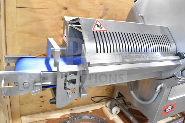 Treif Puma horizontal slicer with commercial casters. Features stainless steel design, safety labels, and conveyor belt. Excellent condition.