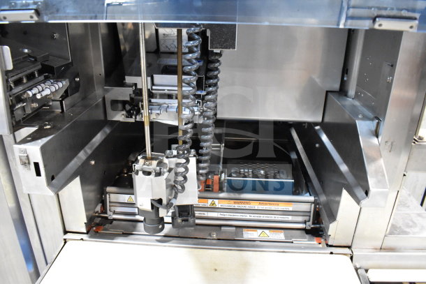 Mettler Toledo 880 Auto commercial floor automatic wrapping machine, metal interior, voltage 200-240V, with warning labels.