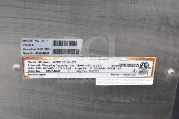 Mettler Toledo 880 Auto Wrapping Machine label detailing model info, serial number, voltage, and manufacture date.