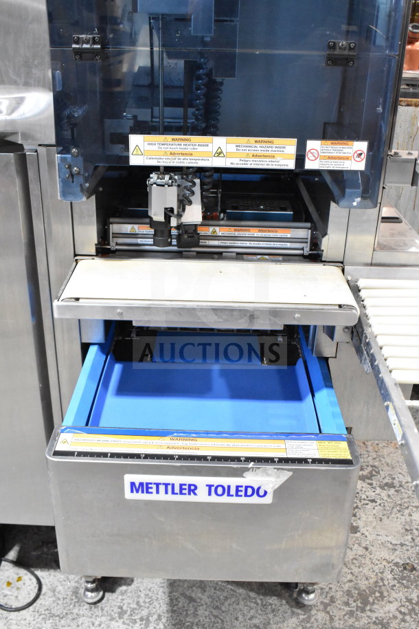 Mettler Toledo 880 Auto commercial floor wrapping machine, 200-240V. Features labels indicating warnings and machine operation details.