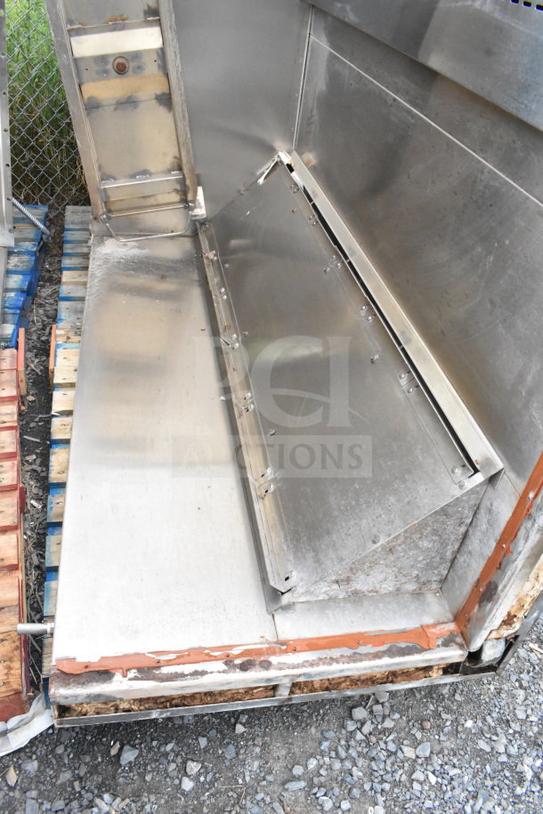 Commercial roll-in rack proofer needing assembly. Features stainless steel interior. Visible wear and assembly required.