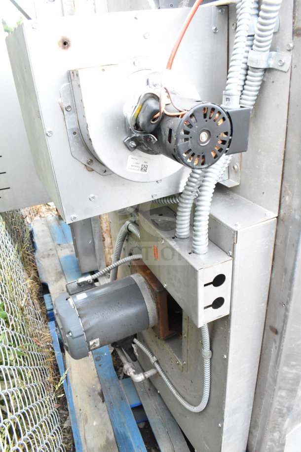 Commercial roll-in rack proofer, metal exterior, needs assembly. Visible electrical components and wiring.