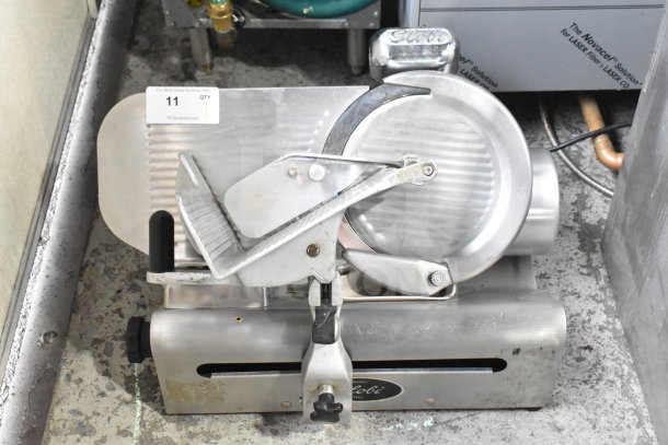 Globe Commercial Countertop Meat Slicer with Blade Sharpener, 115 Volts, 1 Phase, stainless steel, used condition.