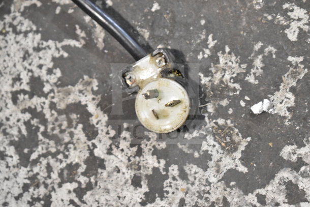 Close-up of AJ Antunes GST-3V Commercial Bun Toaster power plug, showing three-prong configuration. Plug slightly worn.