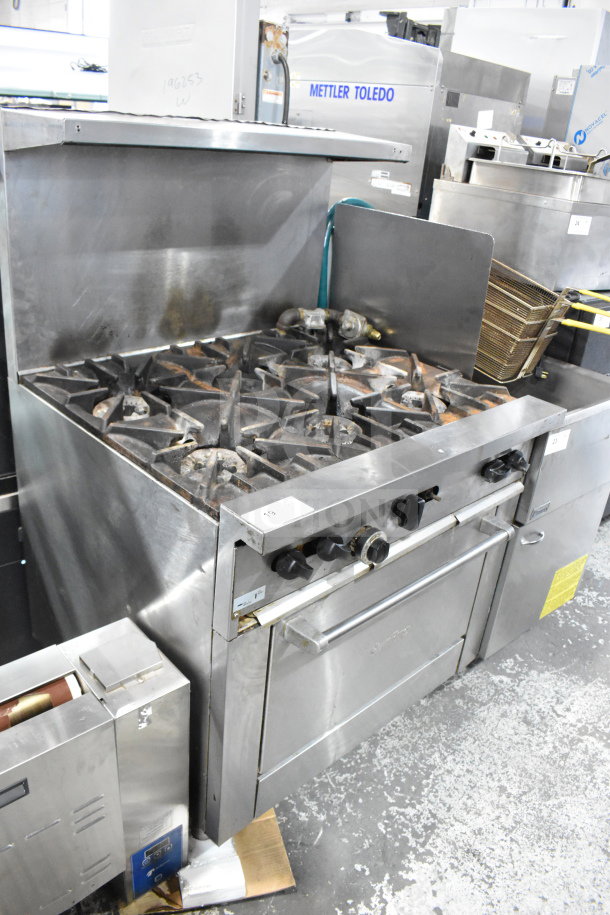Garland SunFire X36-6R Commercial 6 Burner Gas Range with oven, overshelf, and backsplash. Stainless steel, used condition.