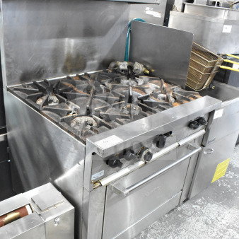 Garland SunFire X36-6R Commercial 6 Burner Gas Range with oven, overshelf, and backsplash. Stainless steel, used condition.