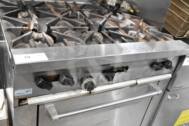 Garland SunFire X36-6R commercial gas range with 6 burners, oven, overshelf. Used condition, visible wear, and markings.