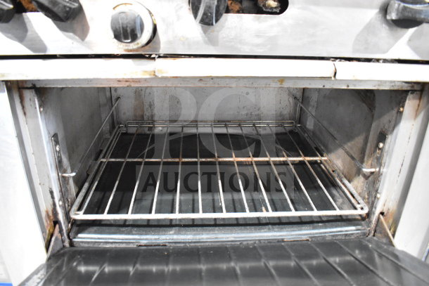 Garland SunFire X36-6R commercial range oven interior, showing metal rack and signs of use.