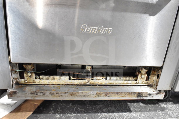 Garland SunFire X36-6R commercial 6 burner range with oven, stainless steel. Visible wear and rust on lower panel.