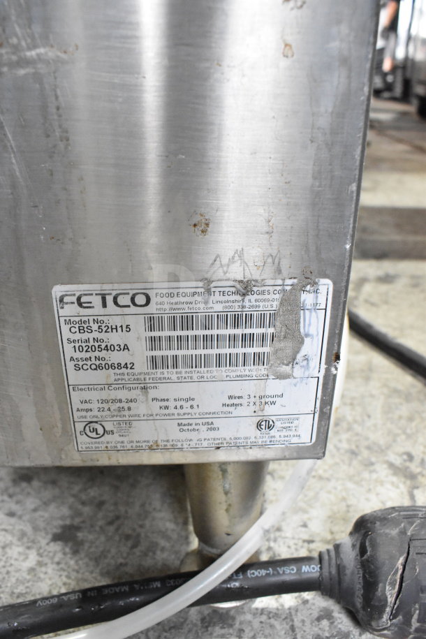 Fetco CBS-52H15 commercial double coffee machine, 120/208-240V, 1 phase. Visible wear, label shows model and serial number.