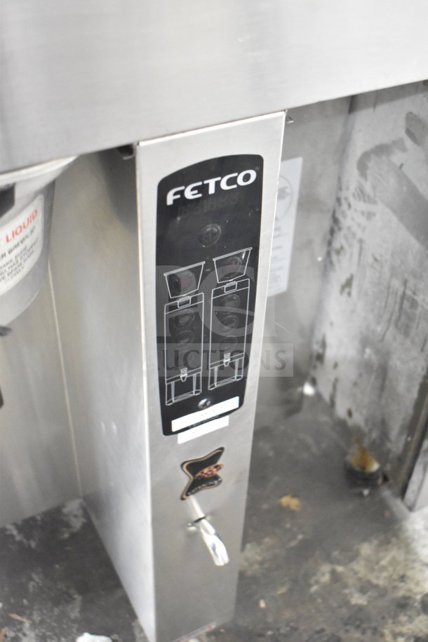 Fetco CBS-2052e commercial countertop double coffee machine, stainless steel. Visible Fetco logo and control panel.