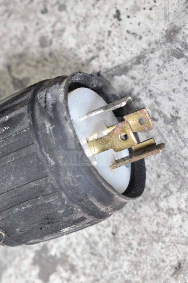 Electrical plug of Fetco CBS-2052e Commercial Coffee Machine, shown with metal prongs and black casing, indicating 120/208-240 Volts compatibility.