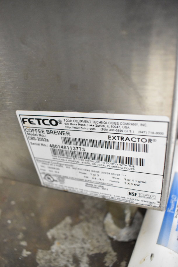 Fetco CBS-2052e commercial coffee machine label, showing model number and electrical specifications, 120/208-240 volts, 1/3 phase.