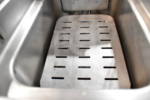 Cooking Performance Group DF-18-2 electric fryer interior, featuring metal fry basket tray. Heavy-duty construction, 30 lb. capacity.