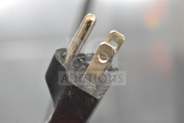 Close-up of a power plug for Vestfrost VC215028011 Red Bull Mini Cooler, showing standard 115V connector.