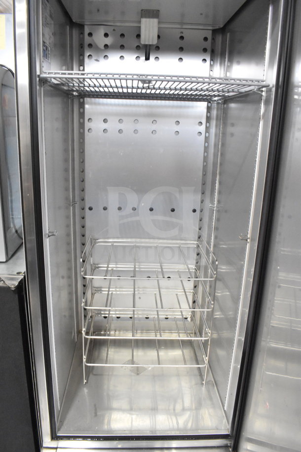 2022 True T-23F-HC single door reach-in freezer, commercial-grade, on casters, 115V, 1 phase. Clean interior, shelves intact.