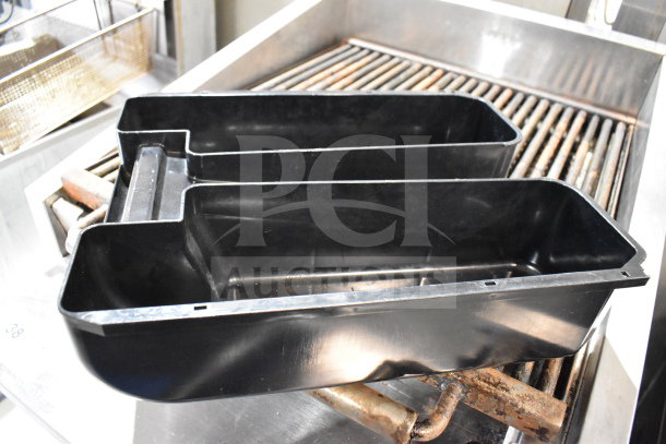 Black plastic container, likely a coffee grounds bin, from a Thermoplan Mastrena M2-CS espresso machine.