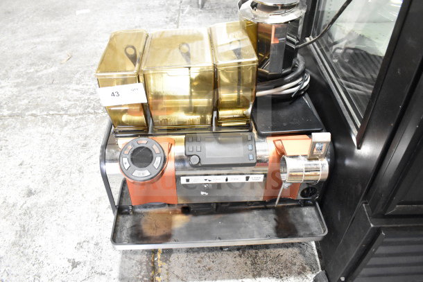 Thermoplan Mastrena M2-CS stainless steel espresso machine with LCD display, three hoppers, and steam wand, in good condition.